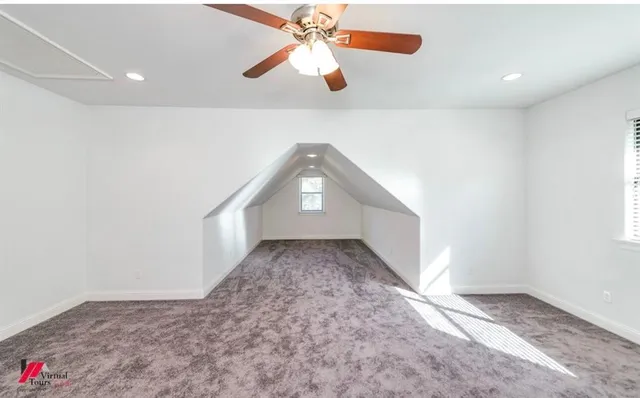 a view of a hallway with a chandelier fan and wooden floor