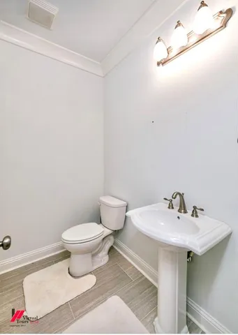 a bathroom with a sink toilet and a mirror