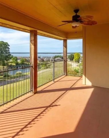 a view of a room with wooden floor and windows