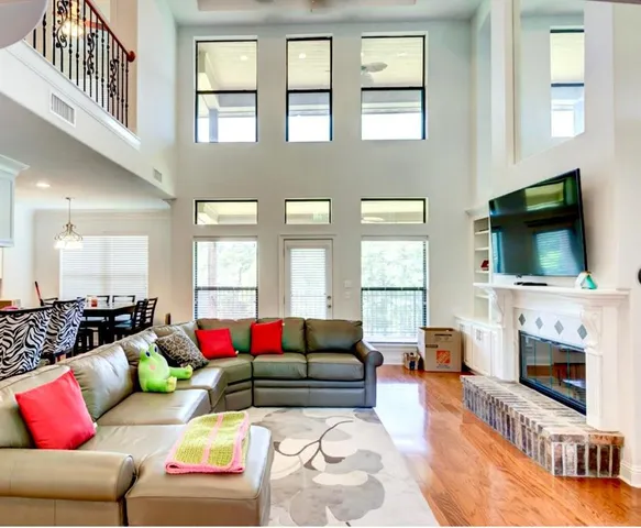a living room with furniture fireplace and flat screen tv