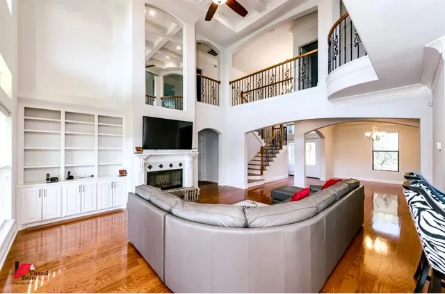 a living room with fireplace furniture and a flat screen tv