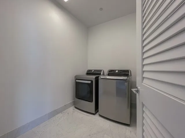 an empty room with closet and windows