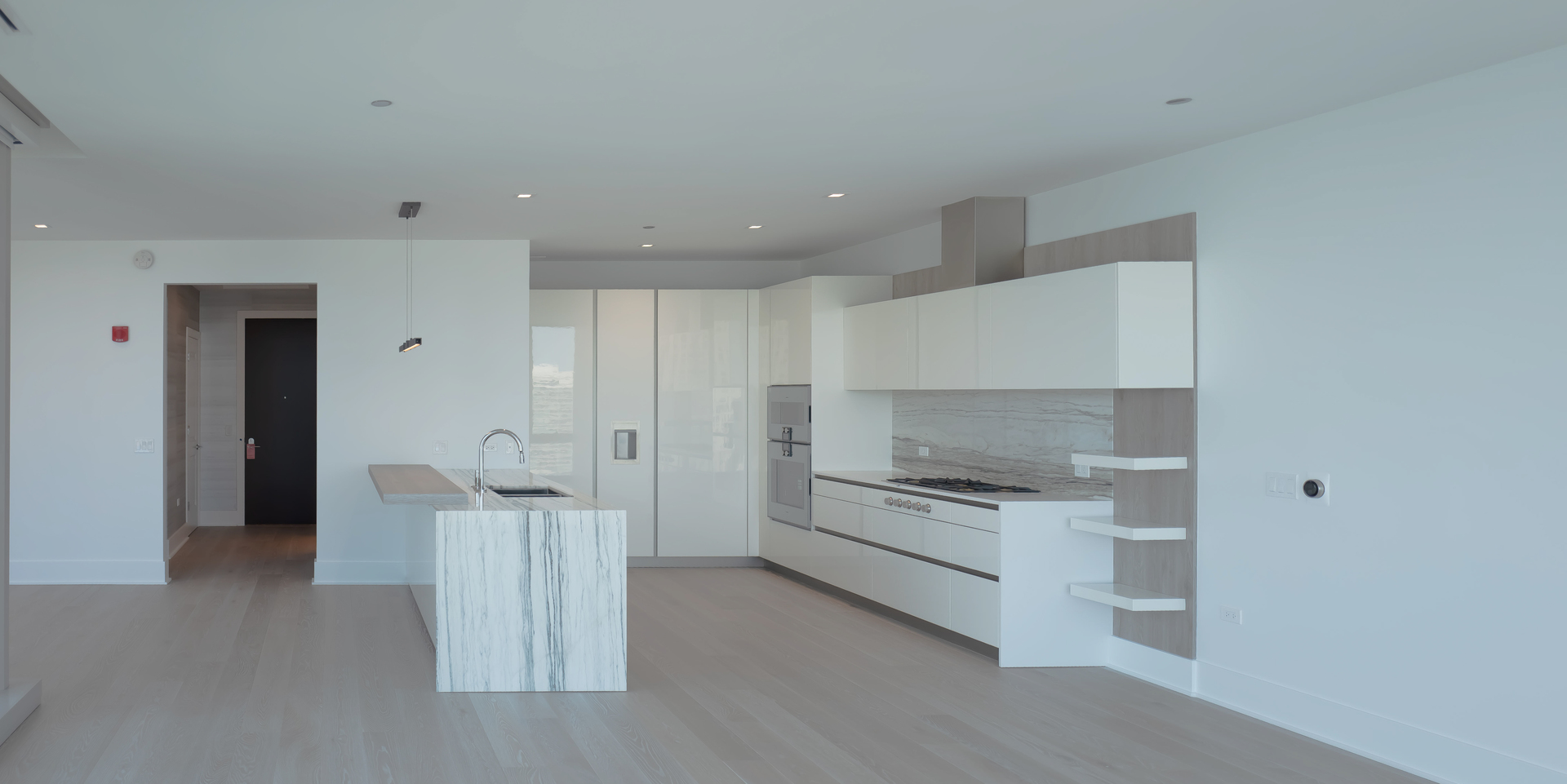 363 East Wacker Drive, Unit 3404 Chicago, IL 60601 - Photo 14 of 22 a kitchen with white cabinets and stainless steel appliances