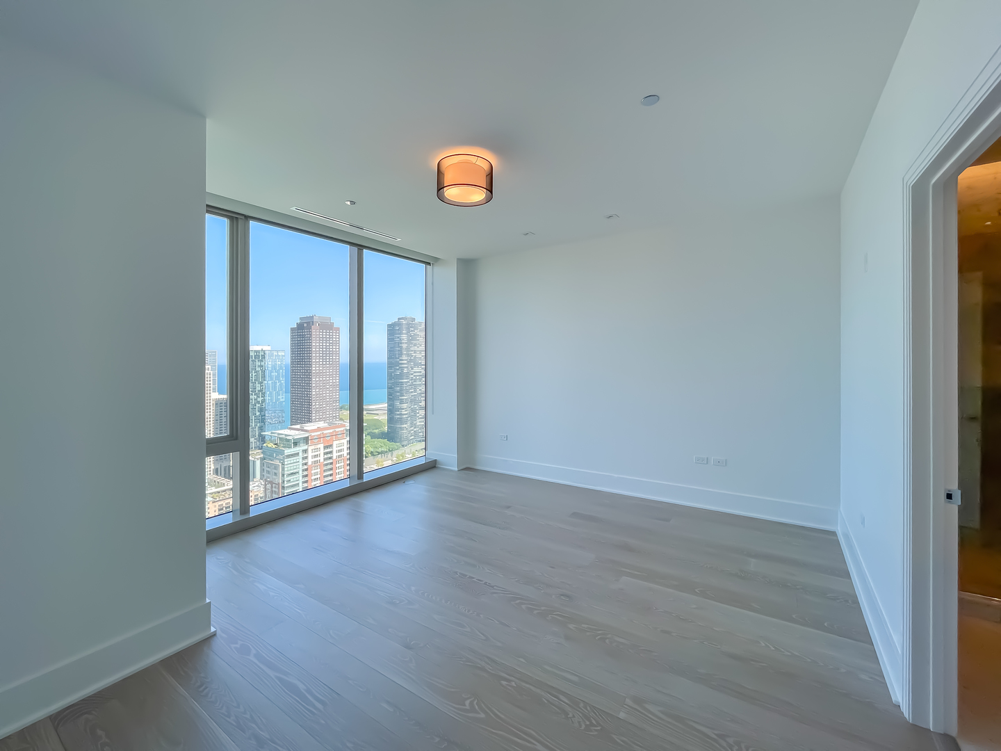 363 East Wacker Drive, Unit 3404 Chicago, IL 60601 - Photo 10 of 22 an empty room with wooden floor and windows