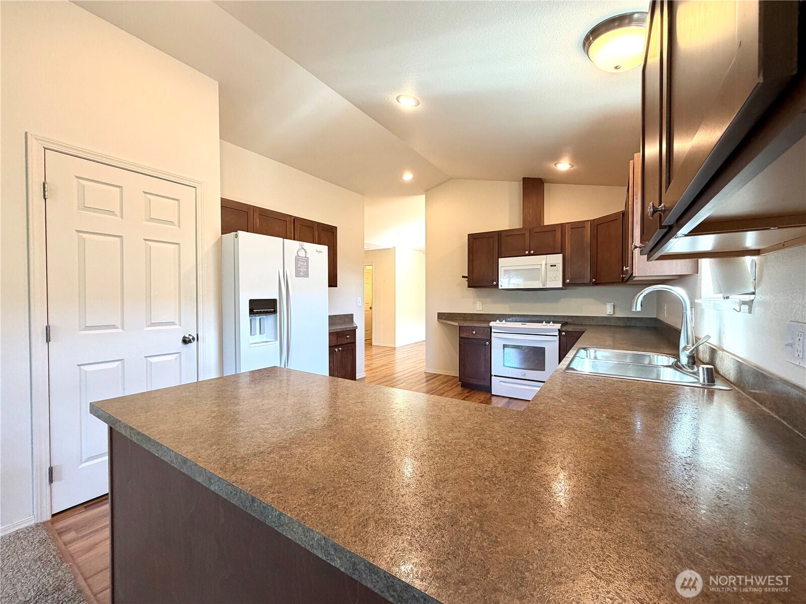 709 Paintbrush Lane Omak, WA 98841 - Photo 12 of 40 a kitchen with stainless steel appliances granite countertop a sink a stove and a refrigerator