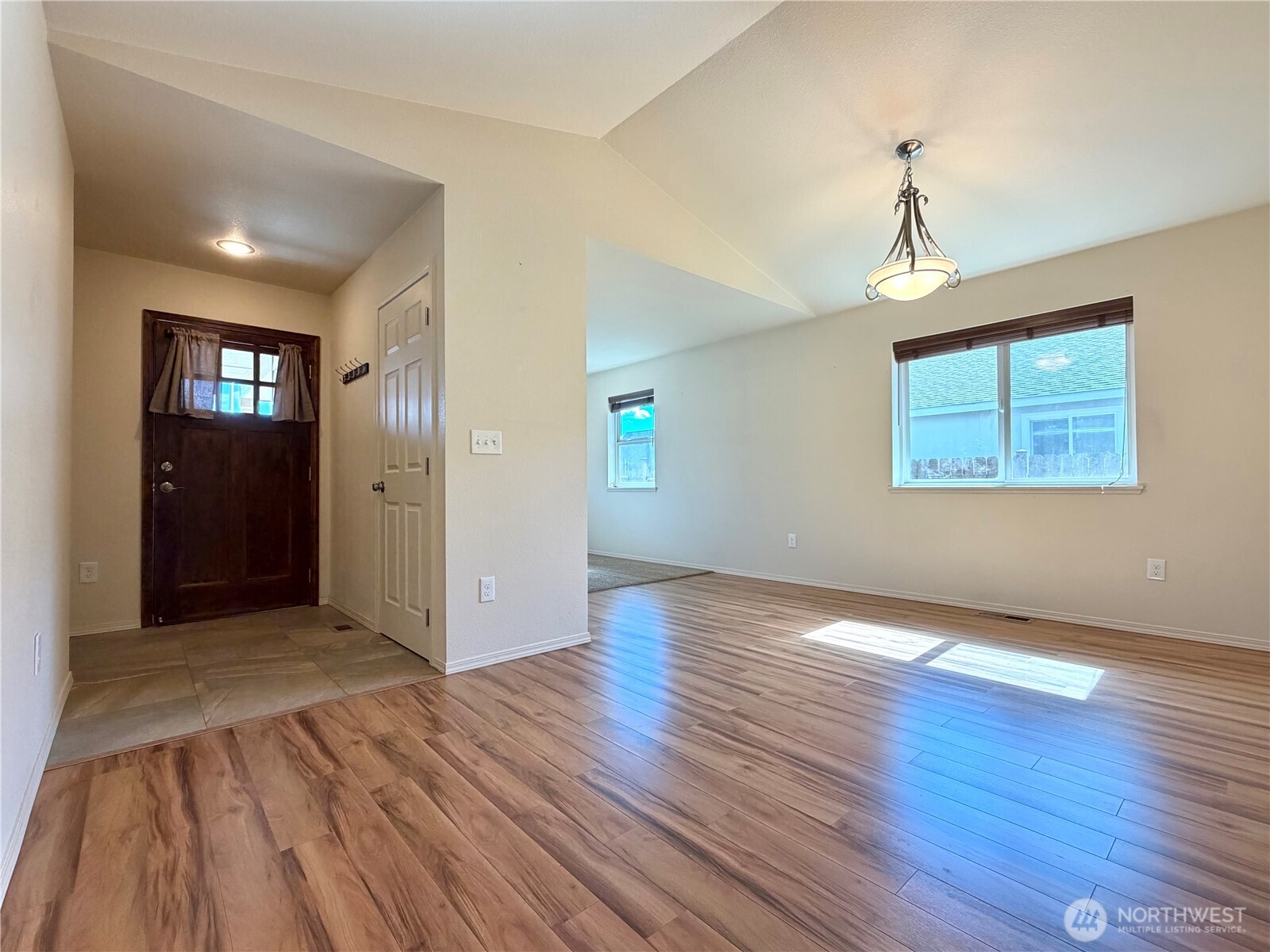 709 Paintbrush Lane Omak, WA 98841 - Photo 5 of 40 a view of an empty room with window and wooden floor