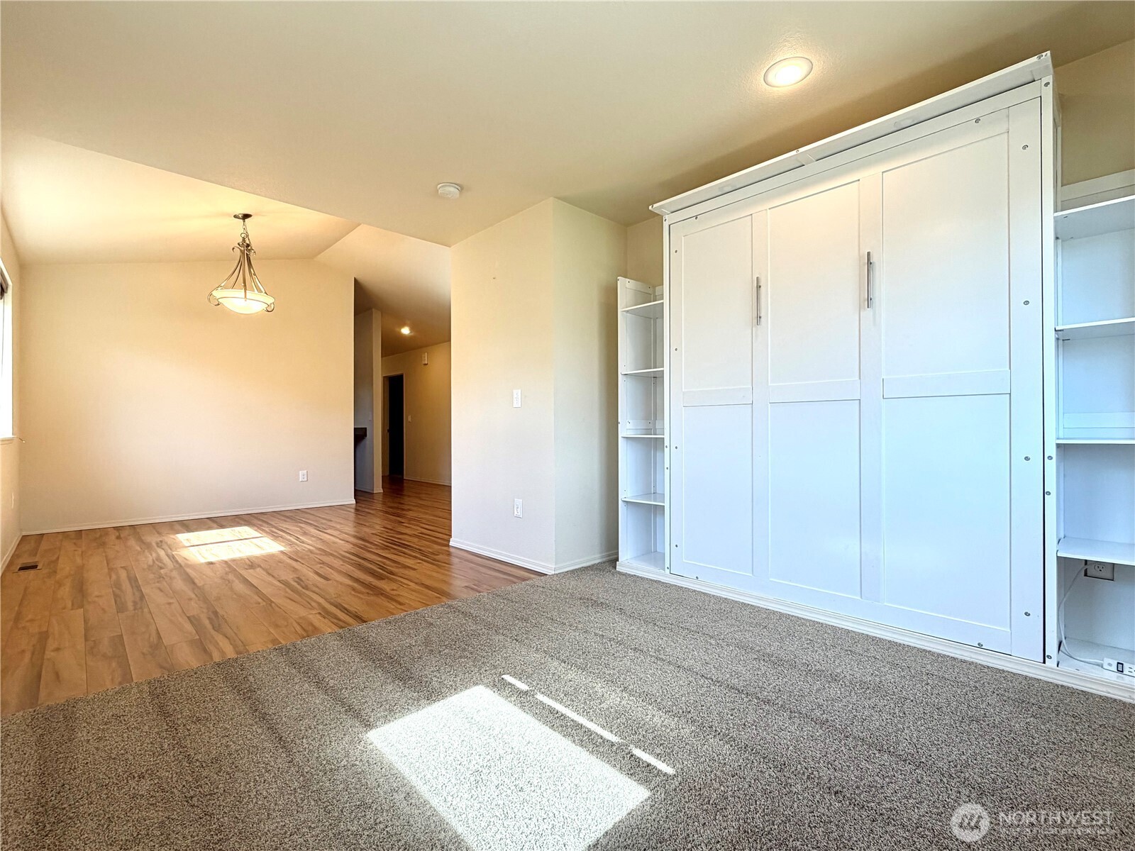 709 Paintbrush Lane Omak, WA 98841 - Photo 7 of 40 a view of an empty room with wooden floor and a bathroom