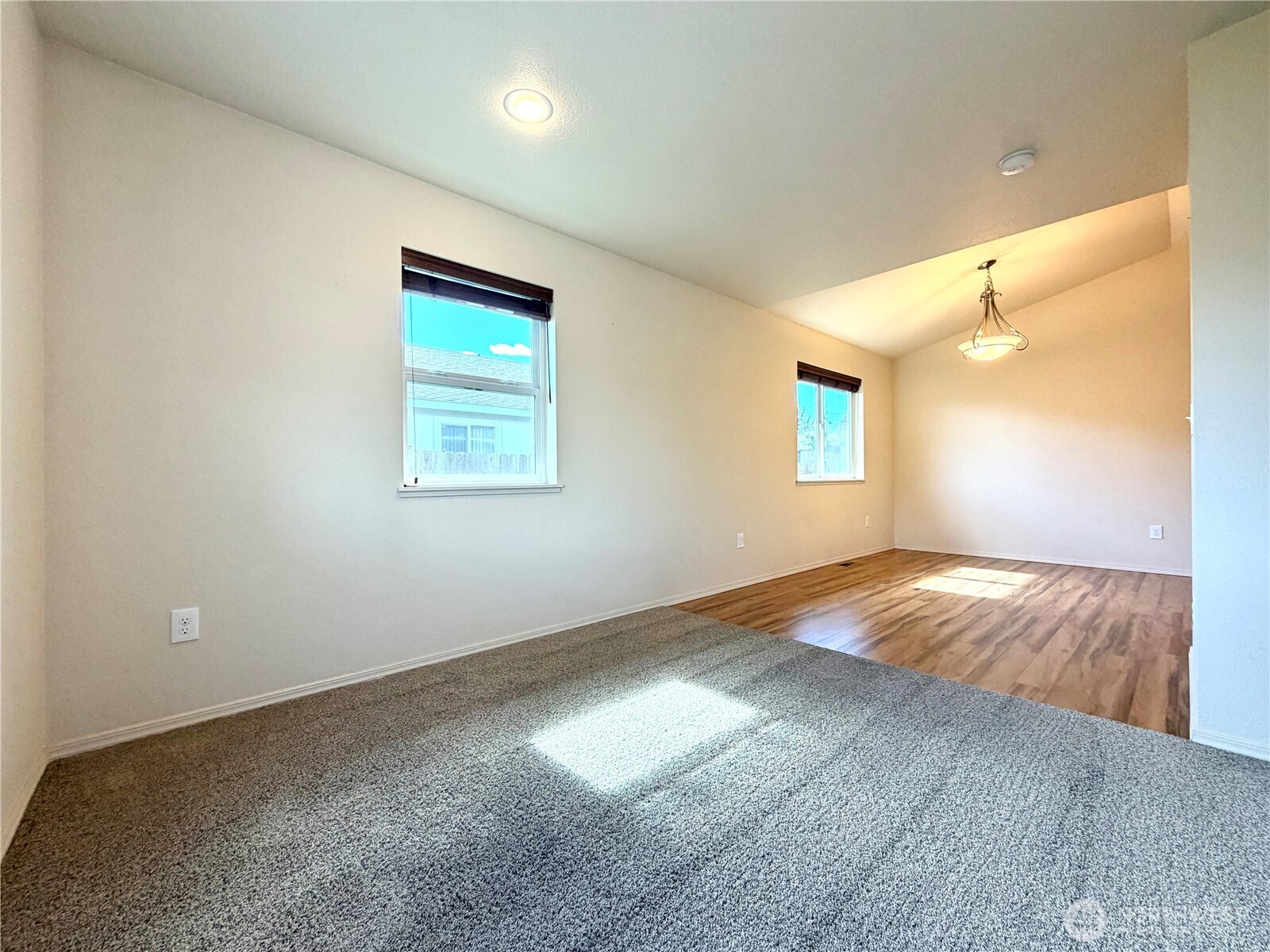 709 Paintbrush Lane Omak, WA 98841 - Photo 8 of 40 an empty room with wooden floor and windows