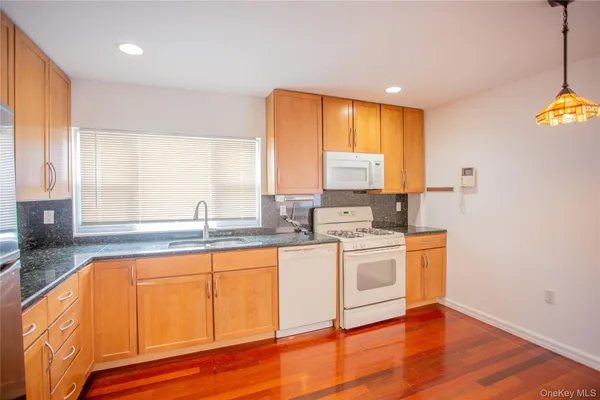 a kitchen with a sink cabinets and window