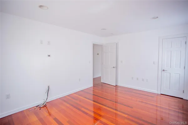 a view of a room with wooden floor