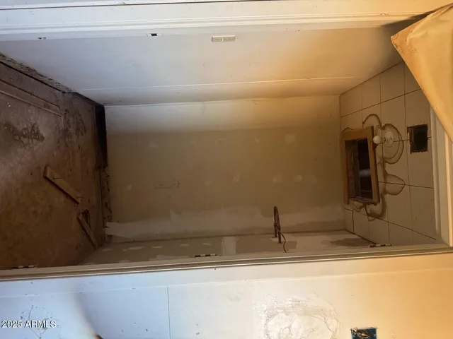 a view of a storage and utility room with washer and dryer