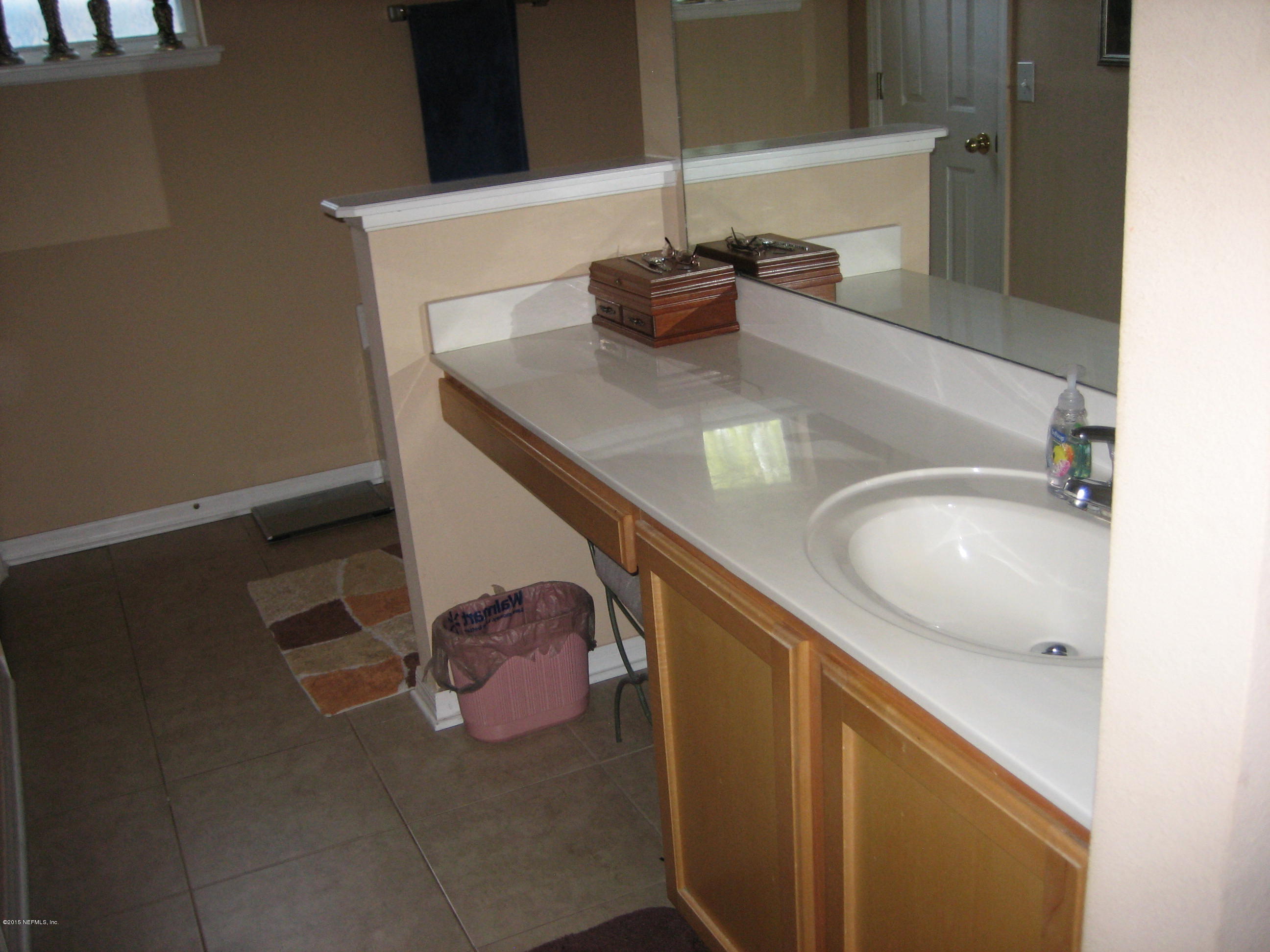 3236 Carlotta Road Middleburg, FL 32068 - Photo 12 of 18 a bathroom with a sink and a mirror