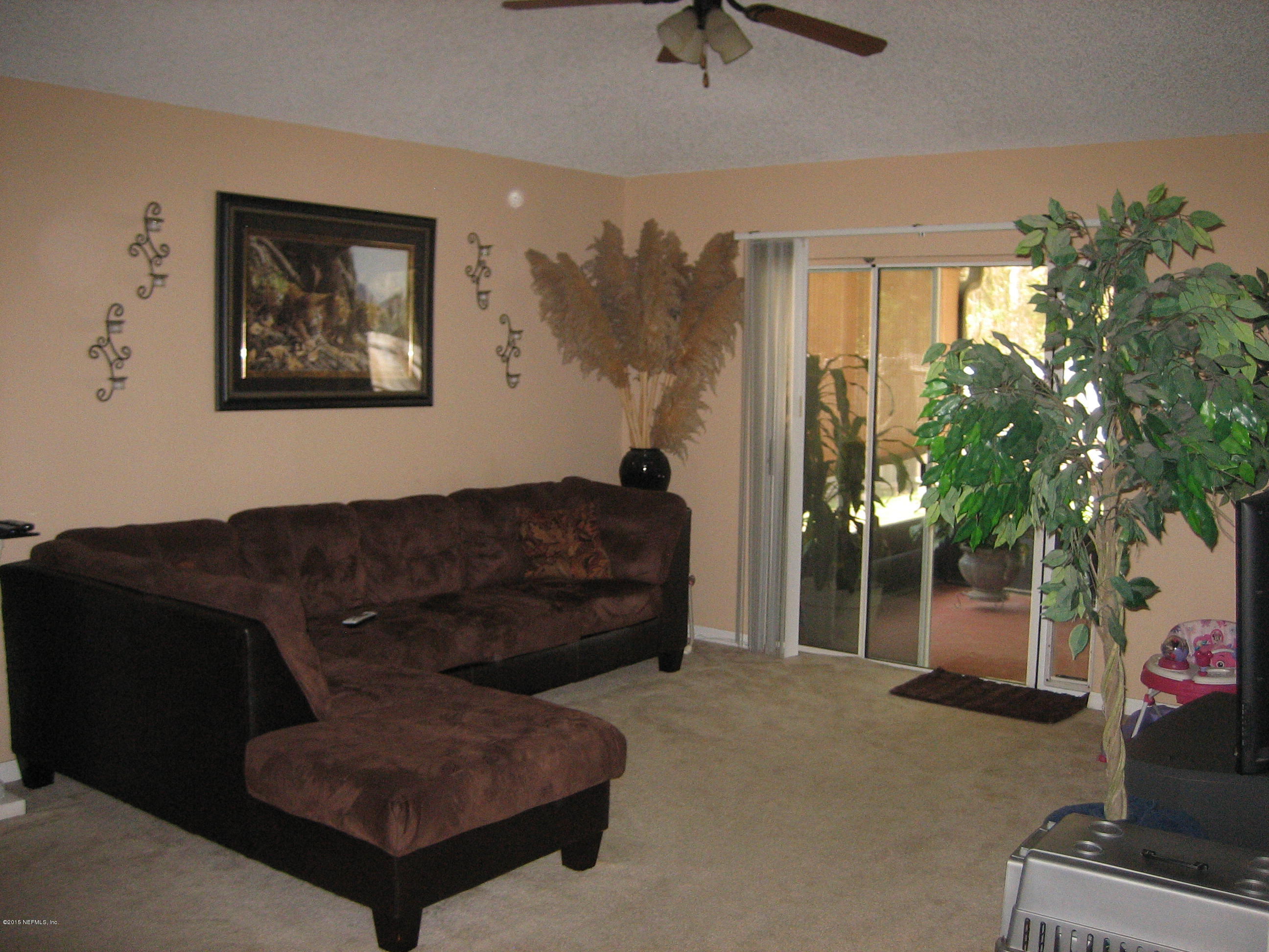 3236 Carlotta Road Middleburg, FL 32068 - Photo 6 of 18 a living room with furniture and a potted plant