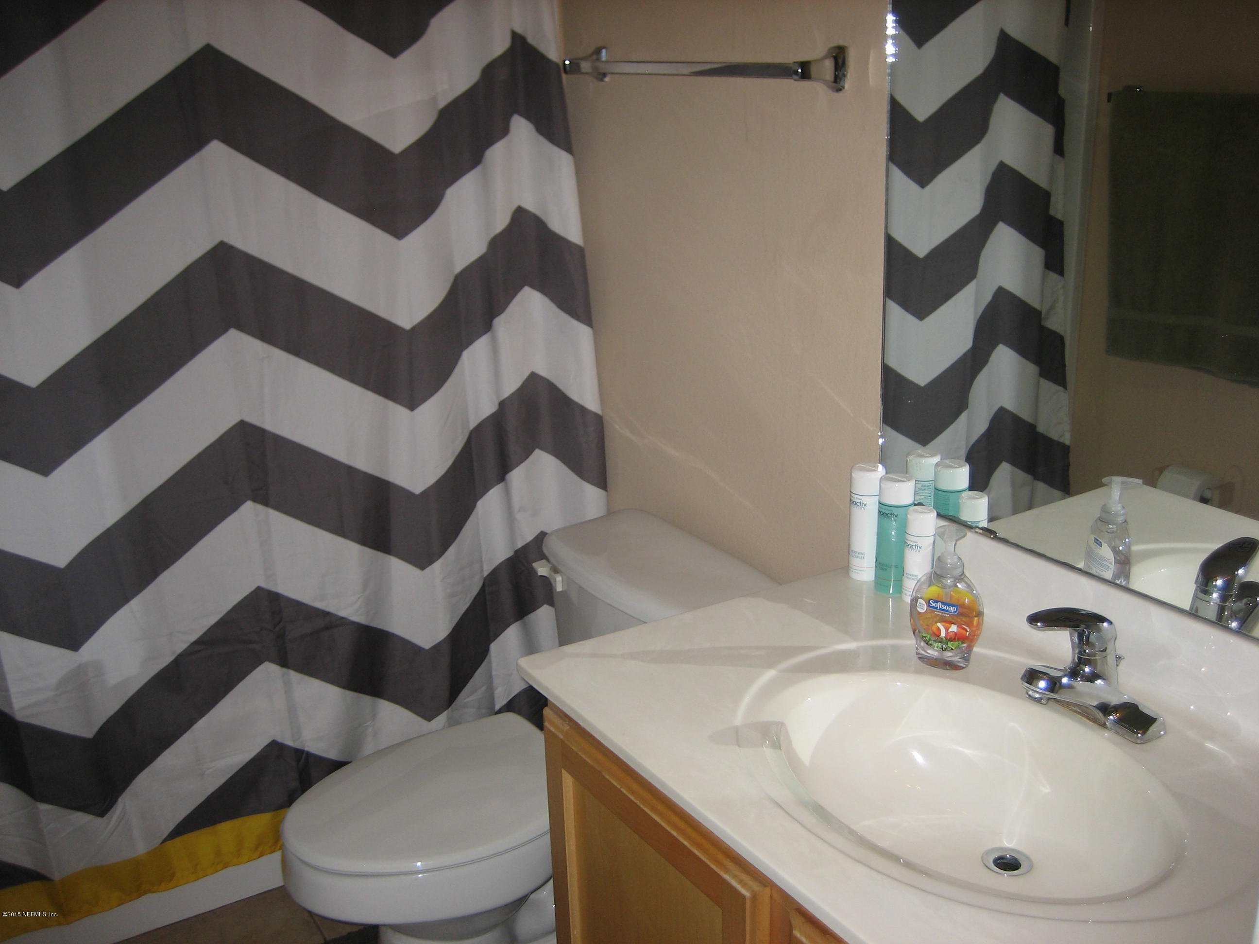 3236 Carlotta Road Middleburg, FL 32068 - Photo 10 of 18 a bathroom with a sink and mirror with toilet