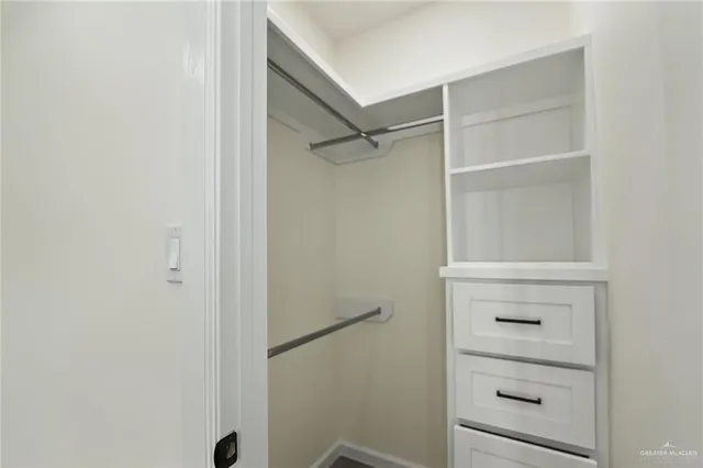 a view of empty room with ceiling fan