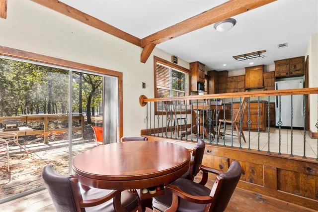 a dining room with furniture and wooden floor