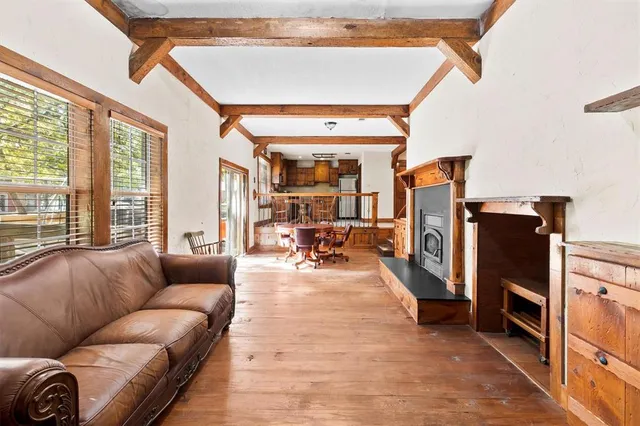 a living room with furniture fireplace and a large window