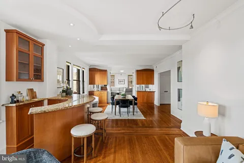 a living room with furniture a window and wooden floor
