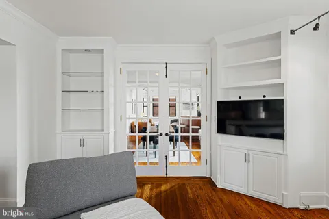 a living room with furniture kitchen view and a window