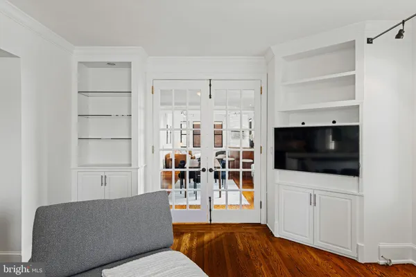 a living room with furniture kitchen view and a window