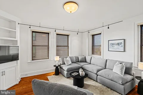 a living room with furniture fireplace and a window