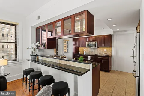 a kitchen with stainless steel appliances granite countertop a stove and a refrigerator