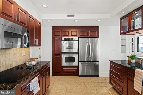a kitchen with stainless steel appliances a stove and a sink