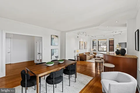 a living room with furniture a table and chairs