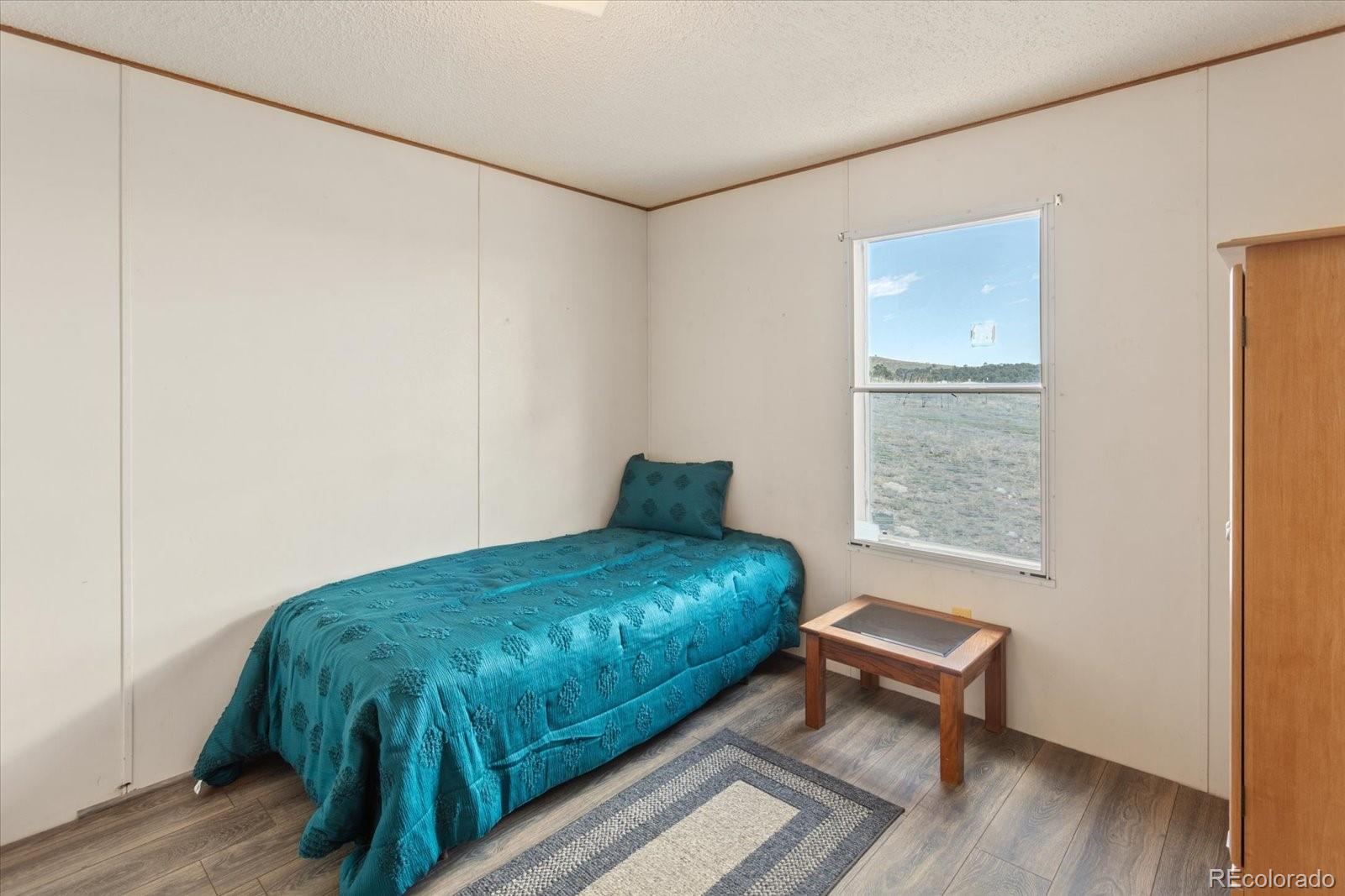2275 K Path Cotopaxi, CO 81223 - Photo 14 of 28 a bed sitting in a bedroom next to a window