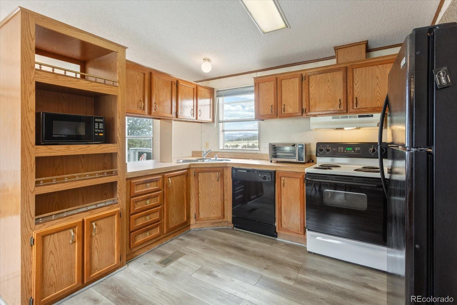 2275 K Path Cotopaxi, CO 81223 - Photo 6 of 28 a kitchen with stainless steel appliances white cabinets and a refrigerator