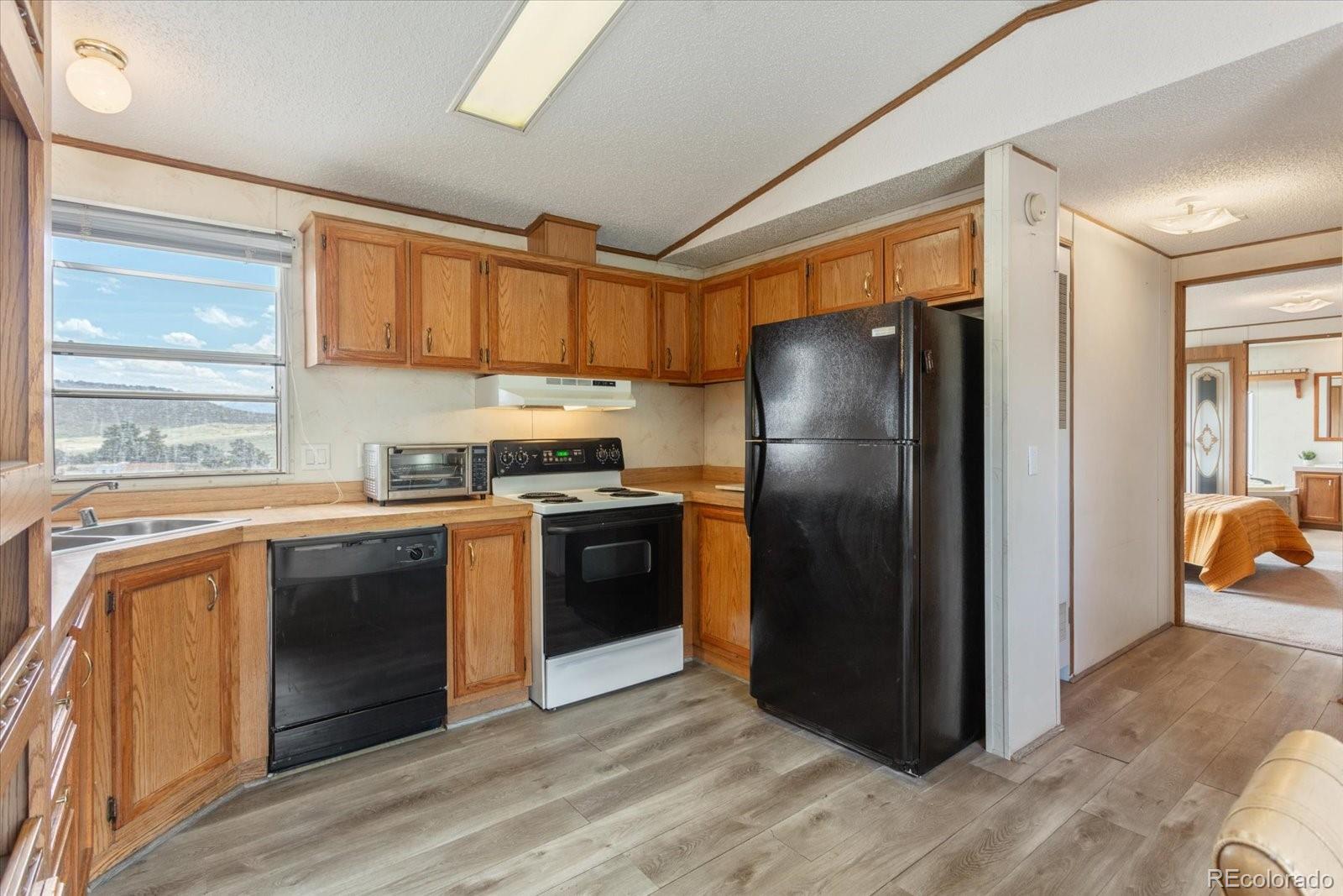 2275 K Path Cotopaxi, CO 81223 - Photo 7 of 28 a kitchen with granite countertop stainless steel appliances a refrigerator cabinets and a sink