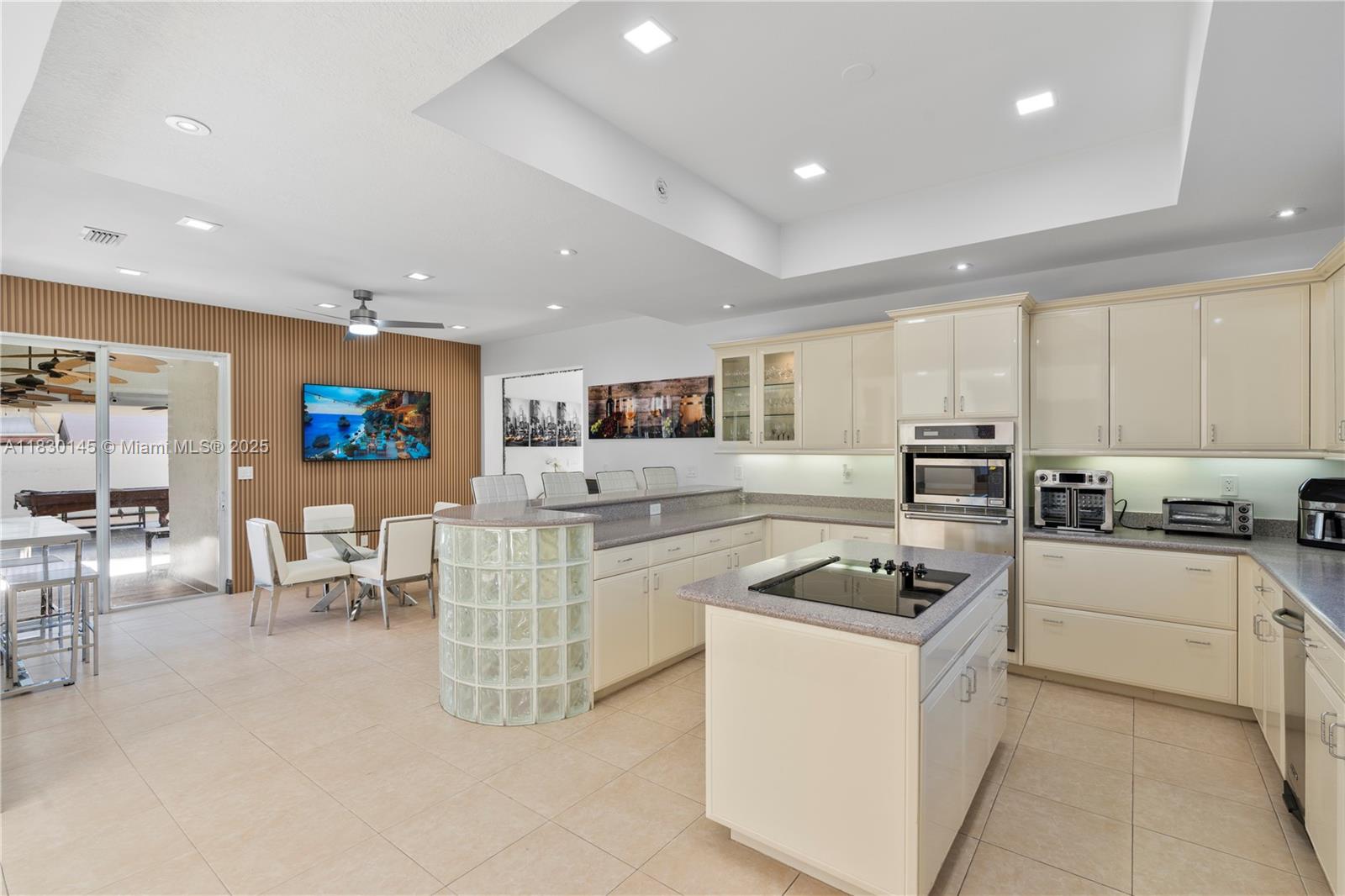 13815 Southwest 38th Street Miami, FL 33175 - Photo 12 of 63 a kitchen with white cabinets and appliances