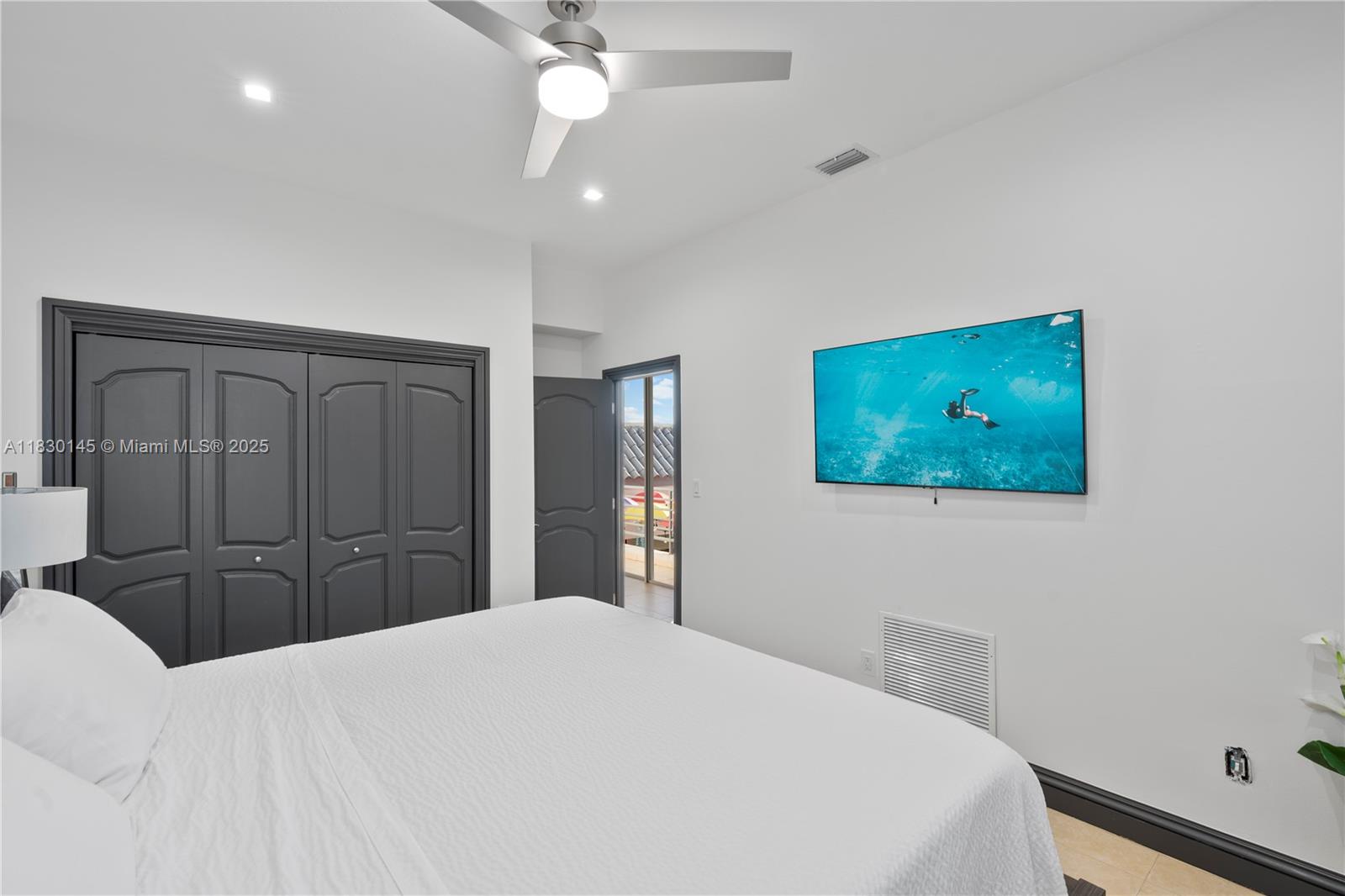 13815 Southwest 38th Street Miami, FL 33175 - Photo 23 of 63 a bedroom with a bed and a chandelier