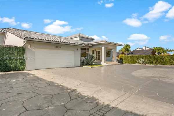 a living room with furniture a large window and wooden floor