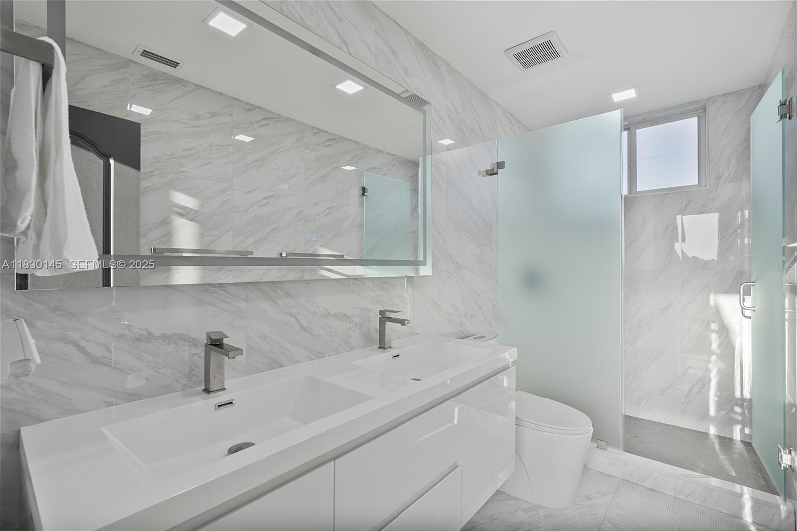 13815 Southwest 38th Street Miami, FL 33175 - Photo 32 of 75 a bathroom with a sink a toilet and a mirror