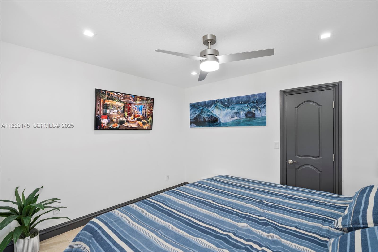 13815 Southwest 38th Street Miami, FL 33175 - Photo 35 of 75 a bedroom with a bed and a painting on the wall