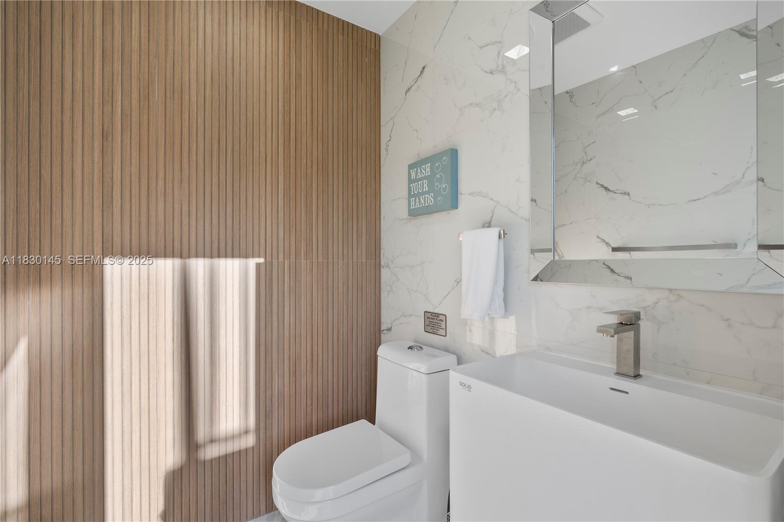 13815 Southwest 38th Street Miami, FL 33175 - Photo 42 of 75 a bathroom with a sink a toilet and shower curtain