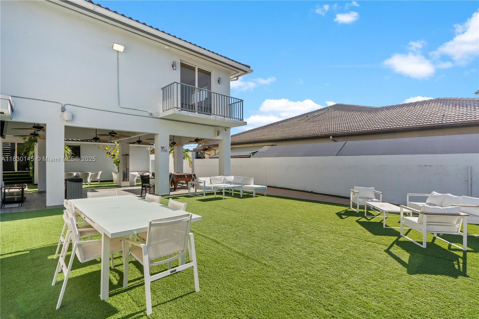 13815 Southwest 38th Street Miami, FL 33175 - Photo 48 of 63 a view of a patio with table and chairs with wooden floor