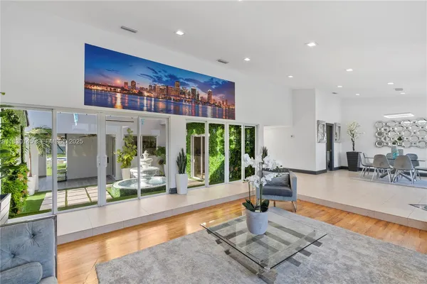 a dining room with furniture and a floor to ceiling window