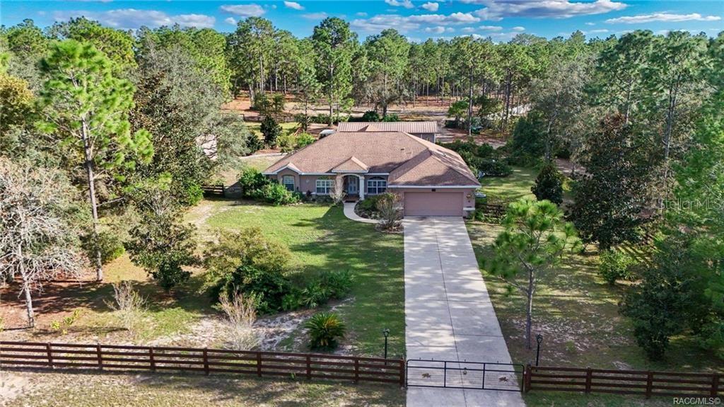 4295 North Bridge Road Beverly Hills, FL 34465 - Photo 2 of 79 a aerial view of a house with yard and green space