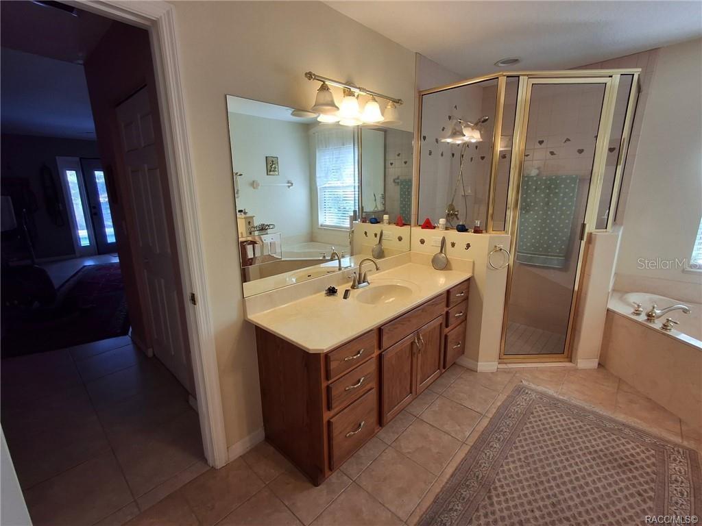 4295 North Bridge Road Beverly Hills, FL 34465 - Photo 23 of 79 a bathroom with a sink double vanity and a mirror