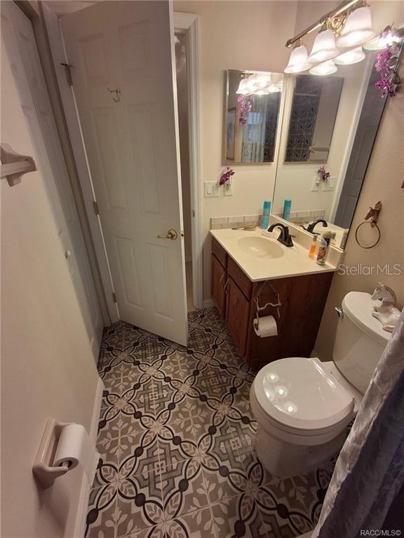 4295 North Bridge Road Beverly Hills, FL 34465 - Photo 27 of 79 a bathroom with a toilet sink and mirror