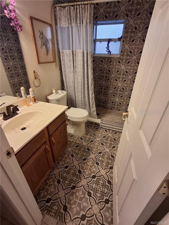 4295 North Bridge Road Beverly Hills, FL 34465 - Photo 28 of 79 a bathroom with a sink toilet and shower