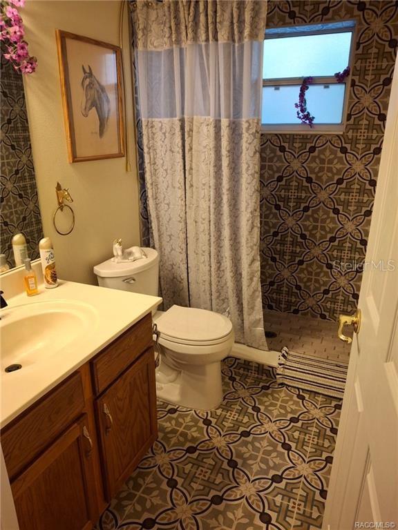 4295 North Bridge Road Beverly Hills, FL 34465 - Photo 29 of 79 a bathroom with a toilet and a sink