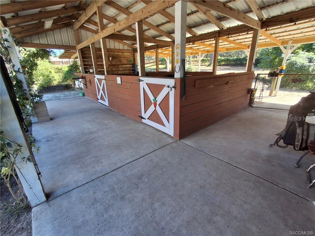 4295 North Bridge Road Beverly Hills, FL 34465 - Photo 35 of 79 a view of a porch with furniture and a gate