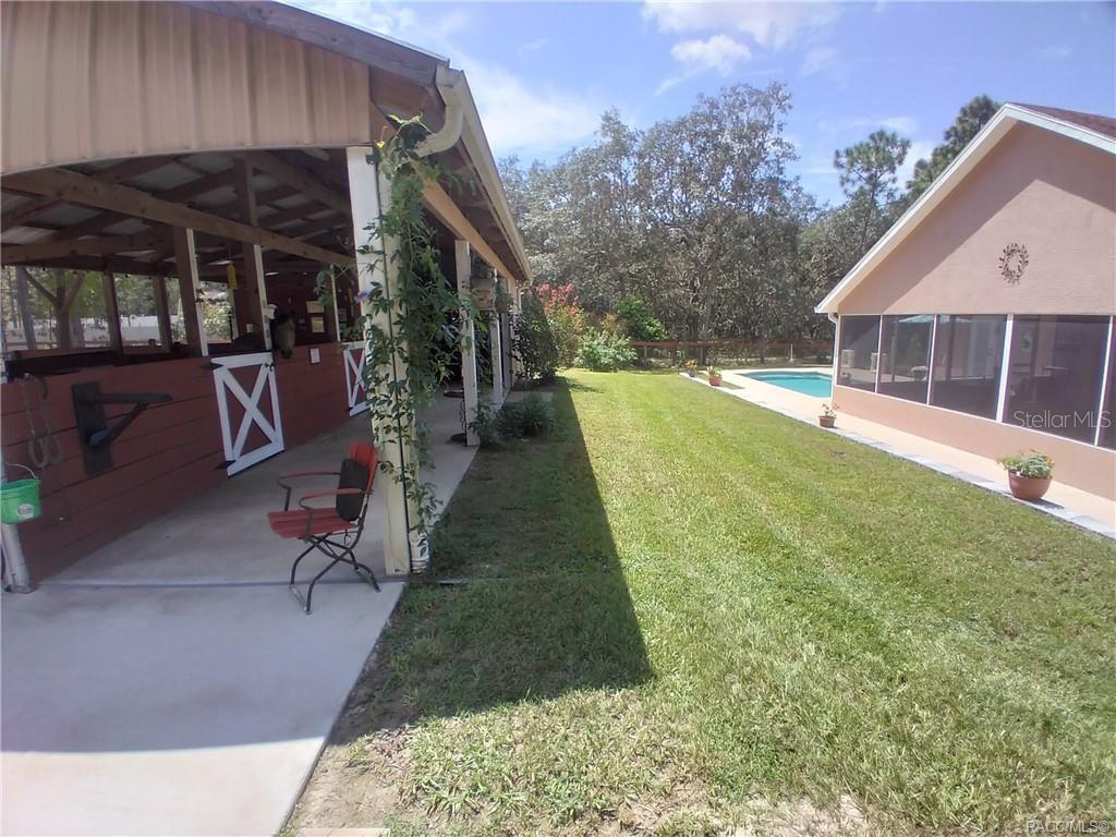 4295 North Bridge Road Beverly Hills, FL 34465 - Photo 40 of 79 a view of house with backyard porch and seating area