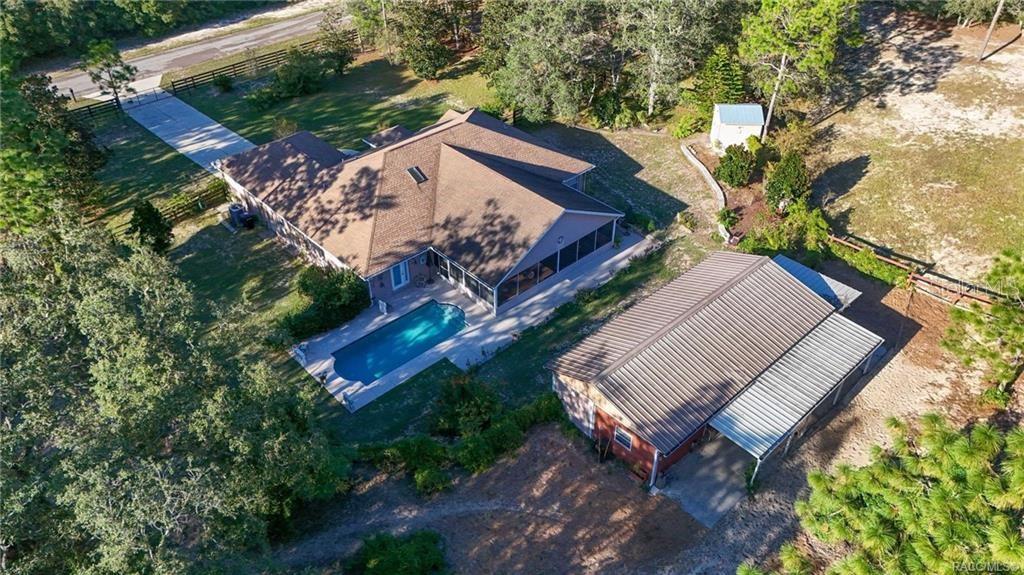 4295 North Bridge Road Beverly Hills, FL 34465 - Photo 4 of 79 an aerial view of a house with a yard and a large tree