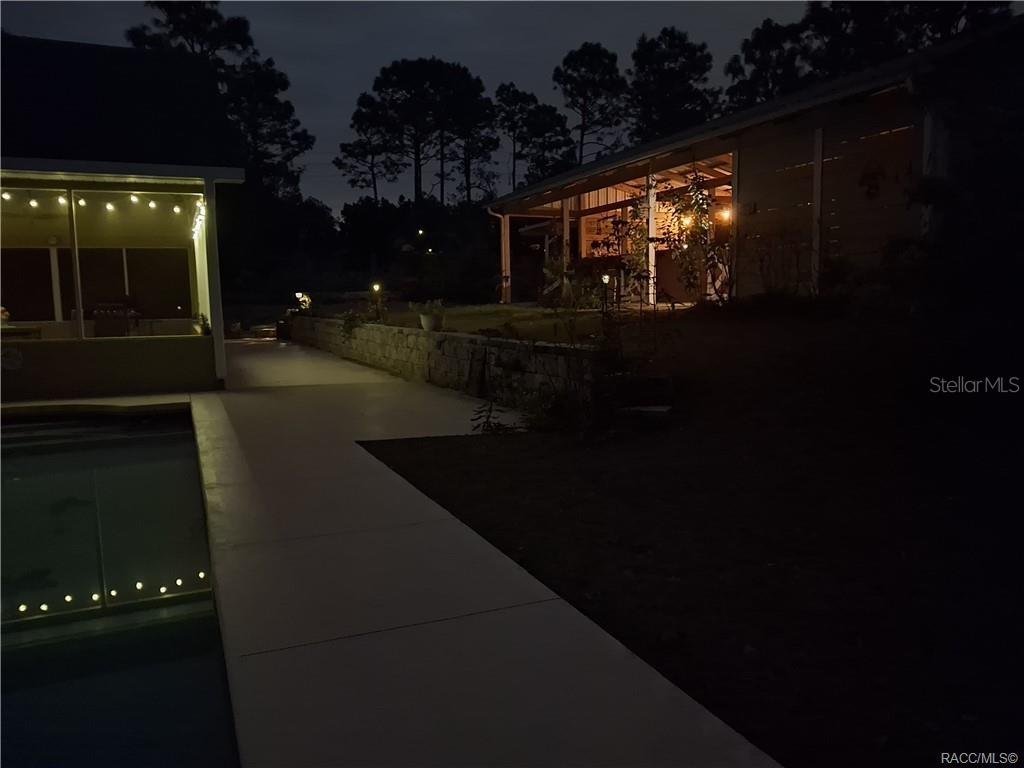 4295 North Bridge Road Beverly Hills, FL 34465 - Photo 45 of 79 a living room with furniture and a floor to ceiling window