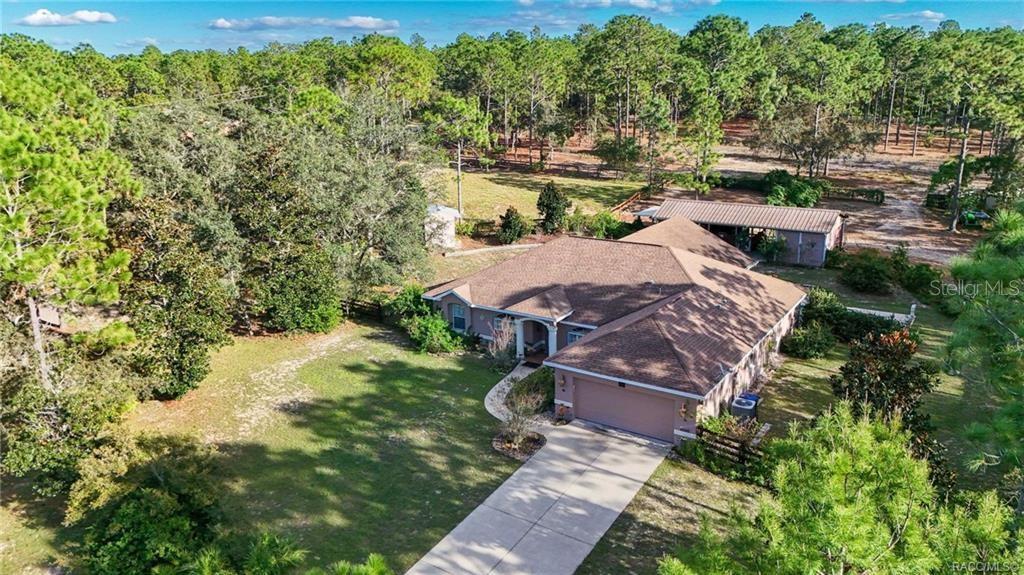 4295 North Bridge Road Beverly Hills, FL 34465 - Photo 51 of 79 a aerial view of a house with yard swimming pool and outdoor seating