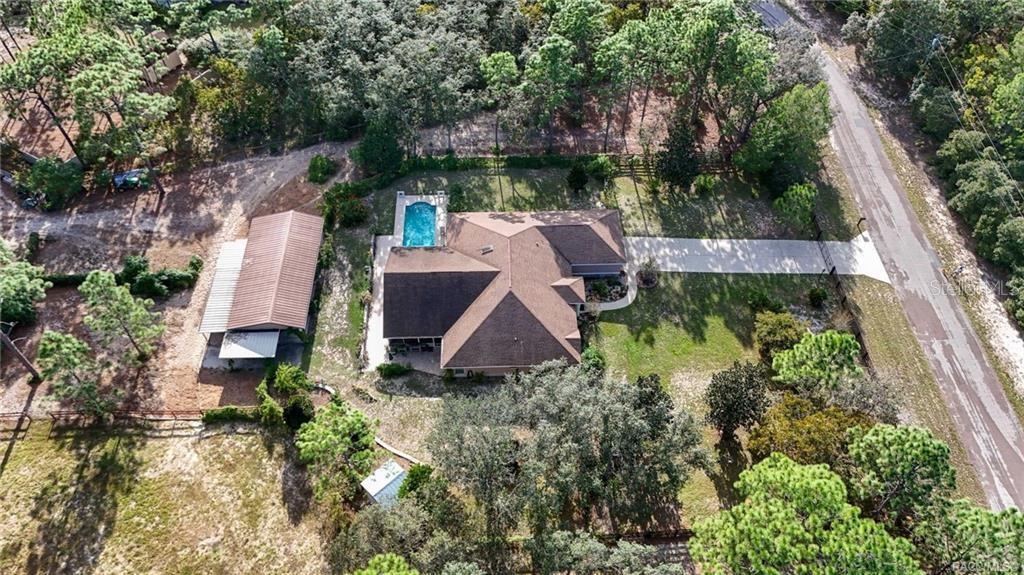 4295 North Bridge Road Beverly Hills, FL 34465 - Photo 53 of 79 an aerial view of a house with a garden